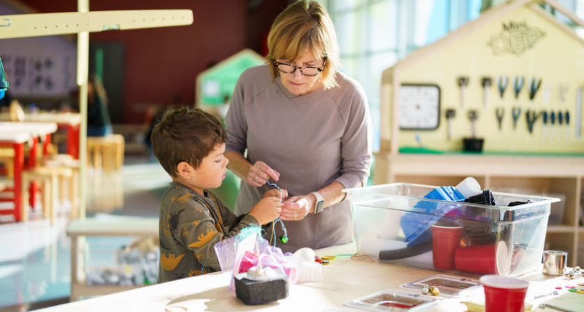 Photo of a child and an adult doing some tinkering 